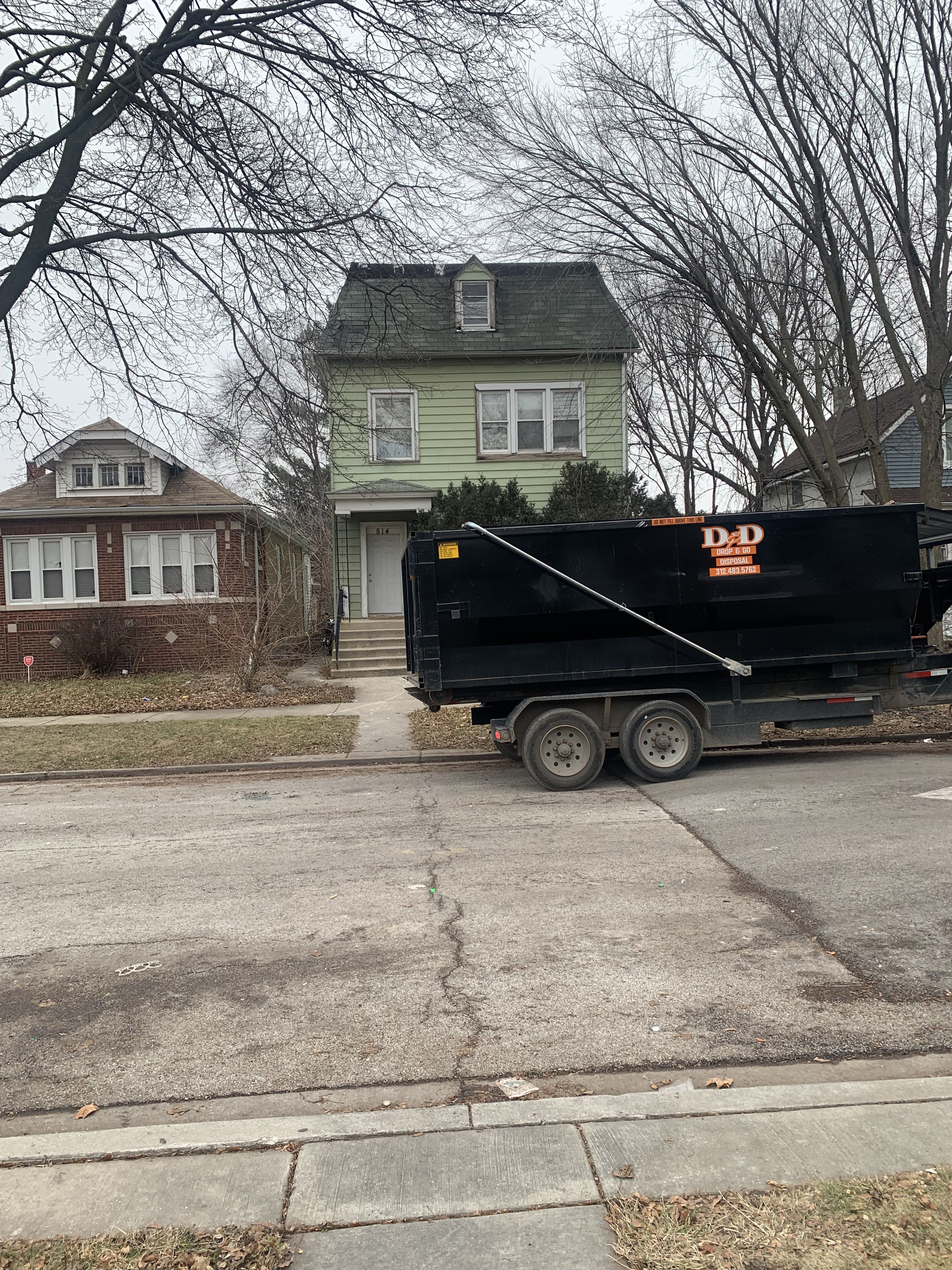 Professional DAPS junk removal team loading furniture and appliances into truck in South Holland, Illinois